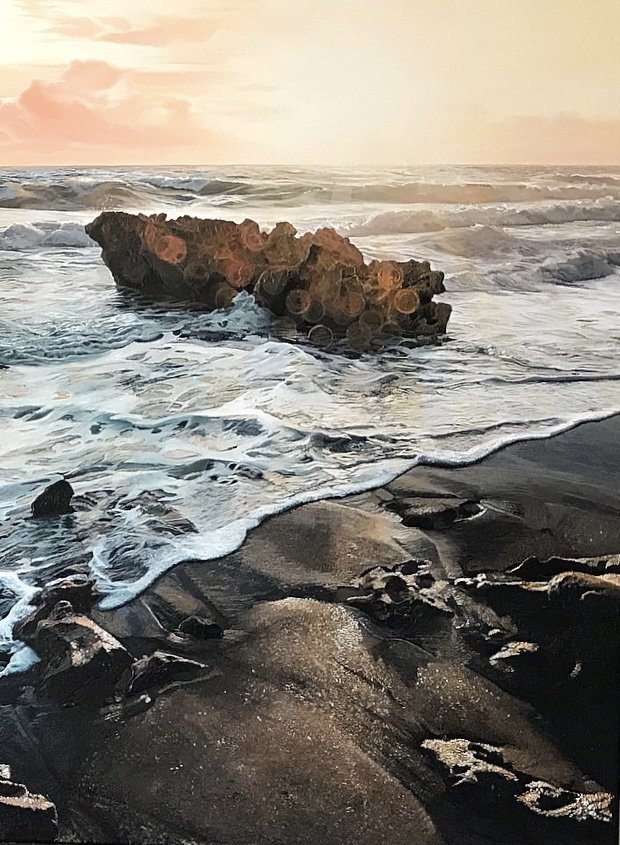 A large seascape painting of a sunrise, with gentles waves caressing the shoreline. textured rocks and details highlighted by the sun rays, by fine artist Andreea Ionela Berindei