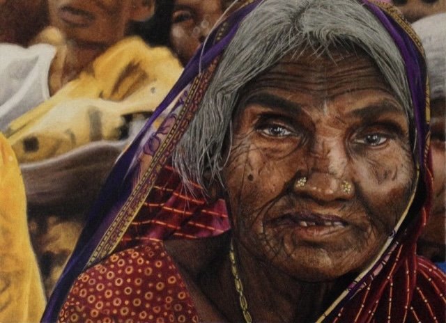 Oil based colour pencil portrait on smooth surface paper of An elderly woman with gray hair, dark skin, and traditional Indian jewellery, wearing a colourful saree, faces the camera in a crowd. By fine artist Andreea Ionela Berindei